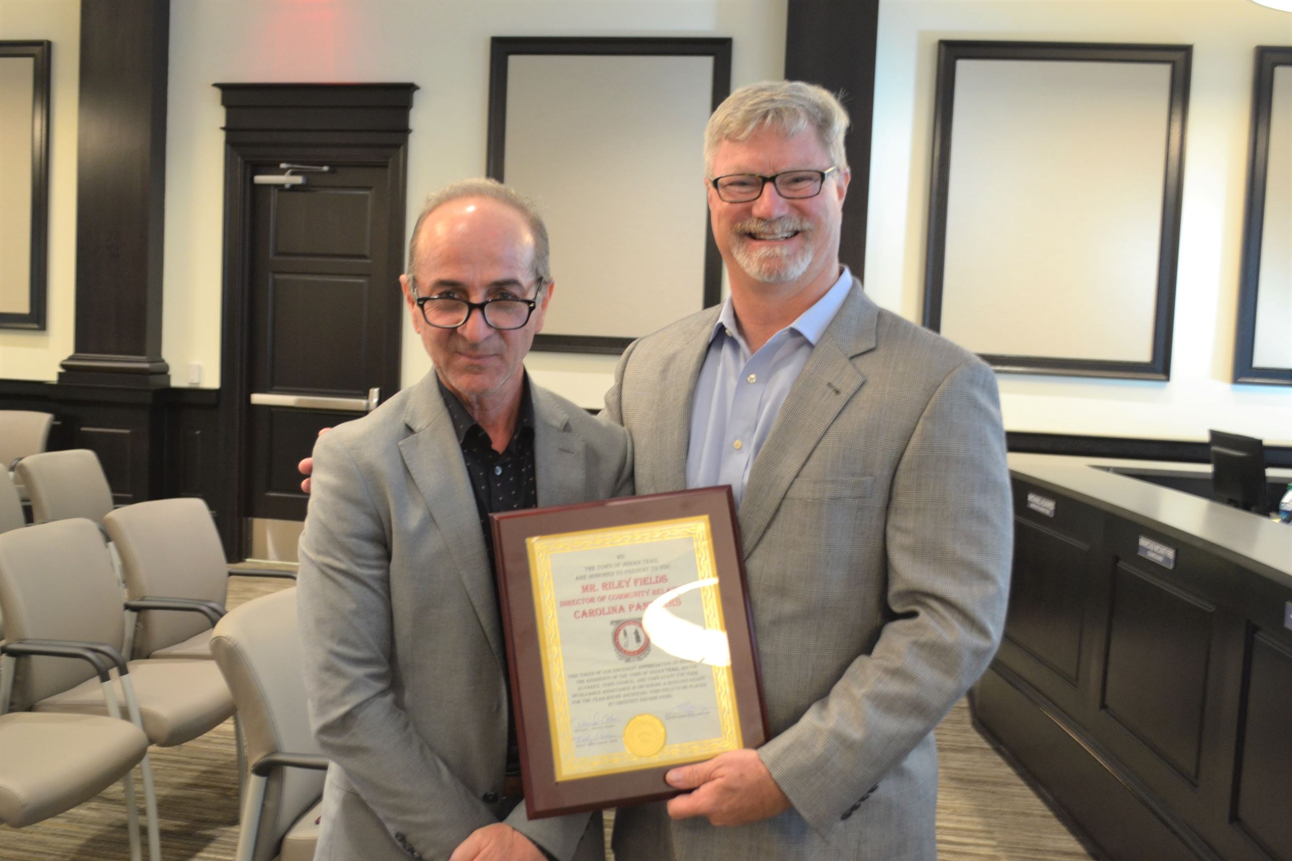 Riley Fields Accepts Plaque from Town Manager Patrick Sadek