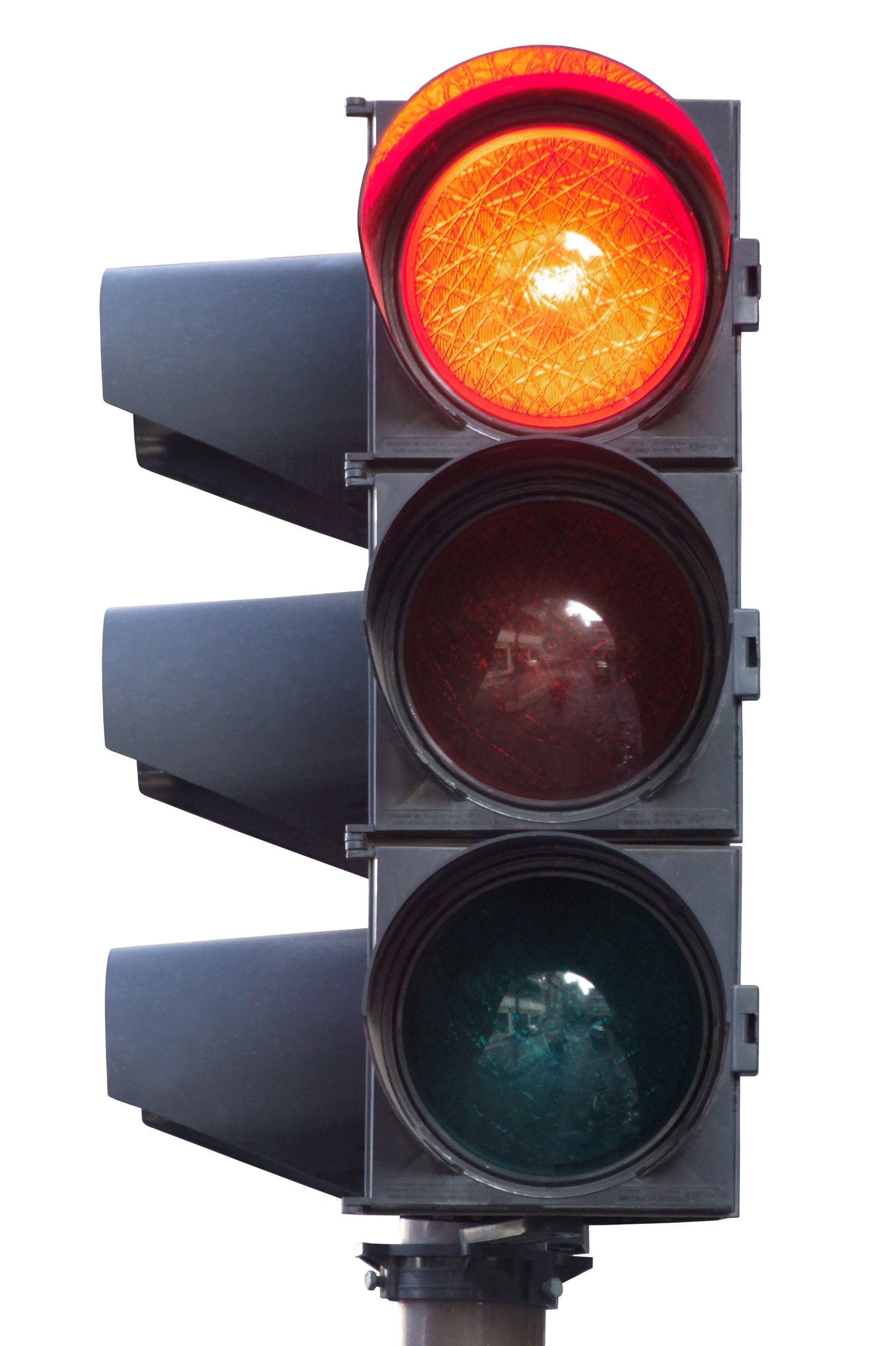 Black traffic light with the red light at the top lit