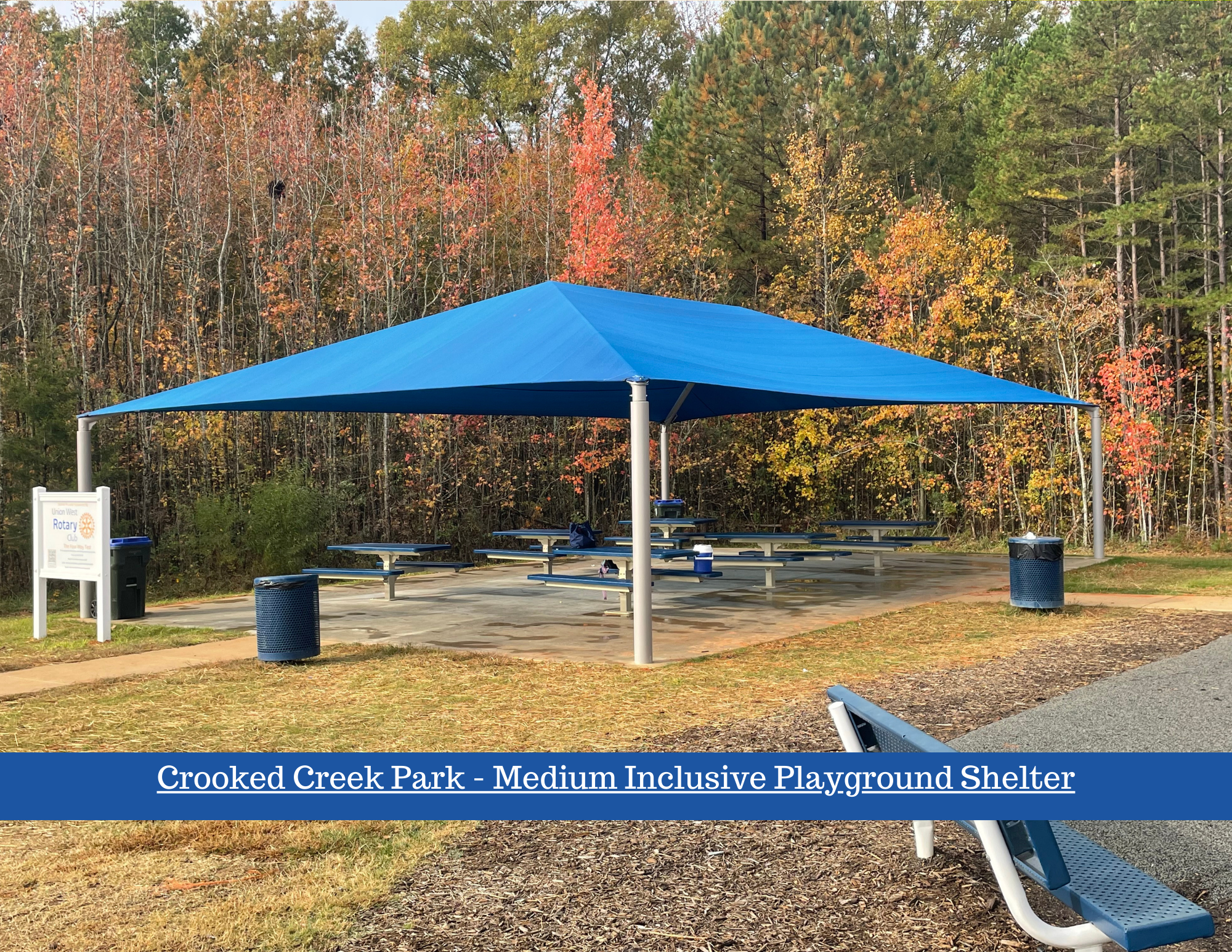 Covered shelter with picnic tables next to ADA compliant playground. 